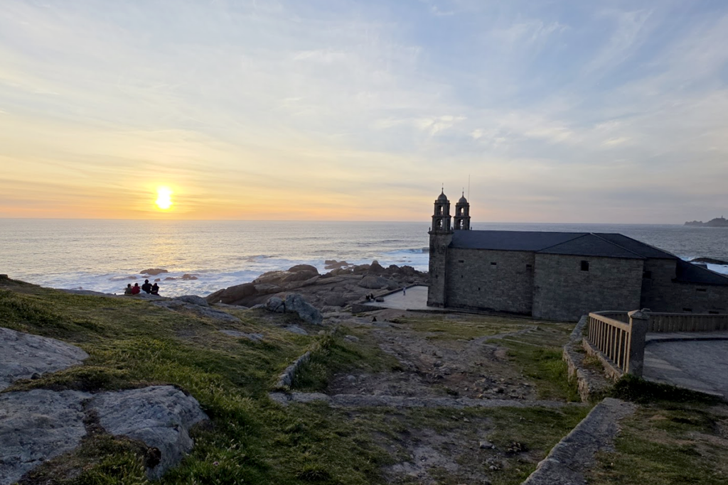 The Santuario da Virxe da Barca is an 18th-century Marian sanctuary located on the rocky shore of Muxía