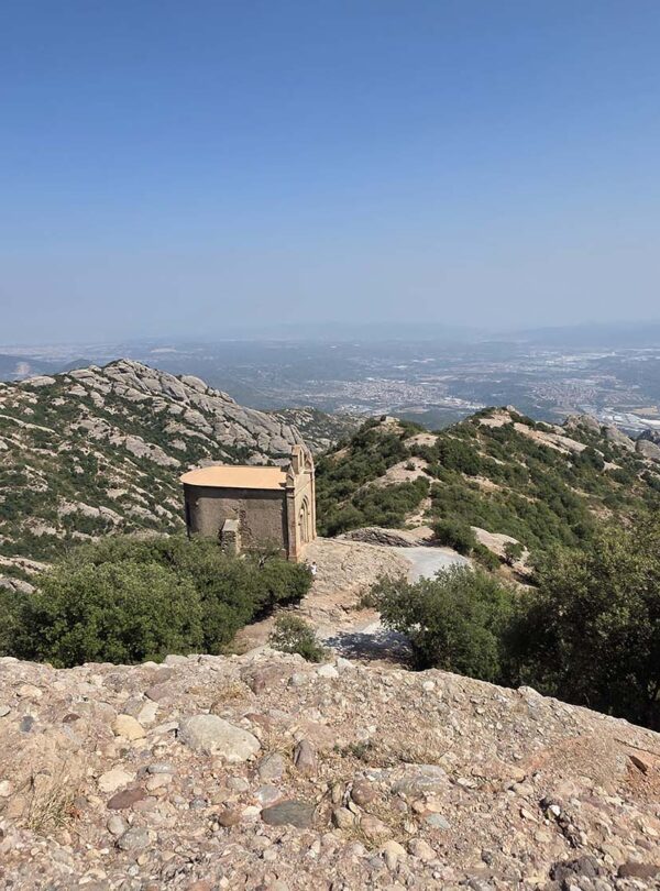 This image features the Ermita de Sant Joan, a chapel located in the Montserrat mountain range near Barcelona, Spain